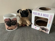 Pug in a mug with a soft toy